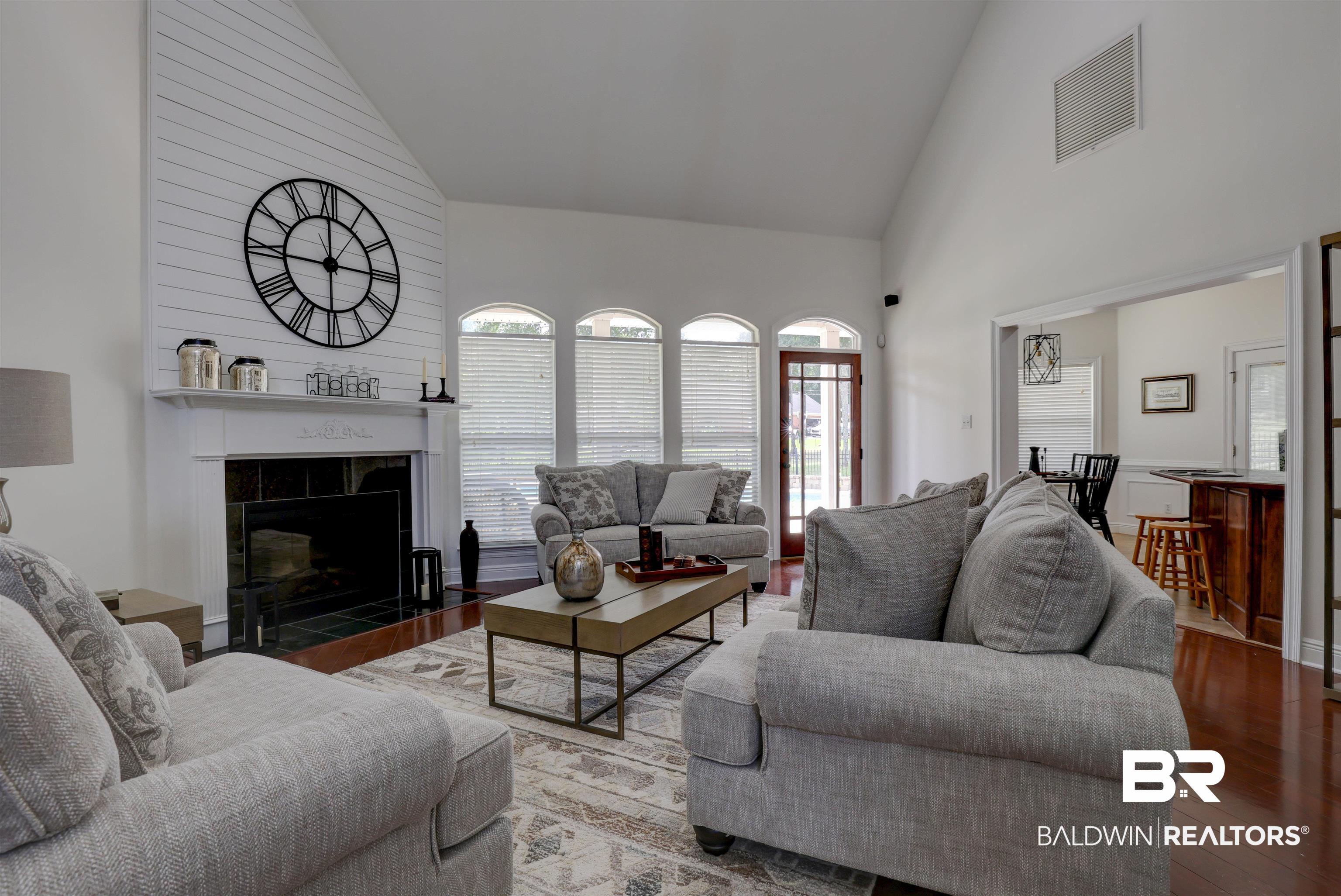 5565 Dawes Lane Theodore, AL 36582 - Photo 7 of 38 Living room featuring high vaulted ceiling, hardwood / wood-style floors, and a tile fireplace