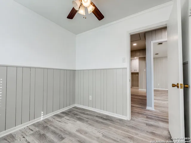 a view of an empty room and wooden floor