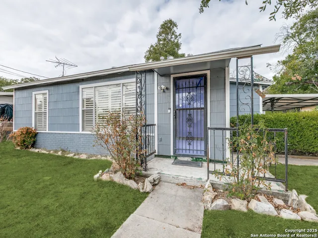 a front view of house with yard and green space