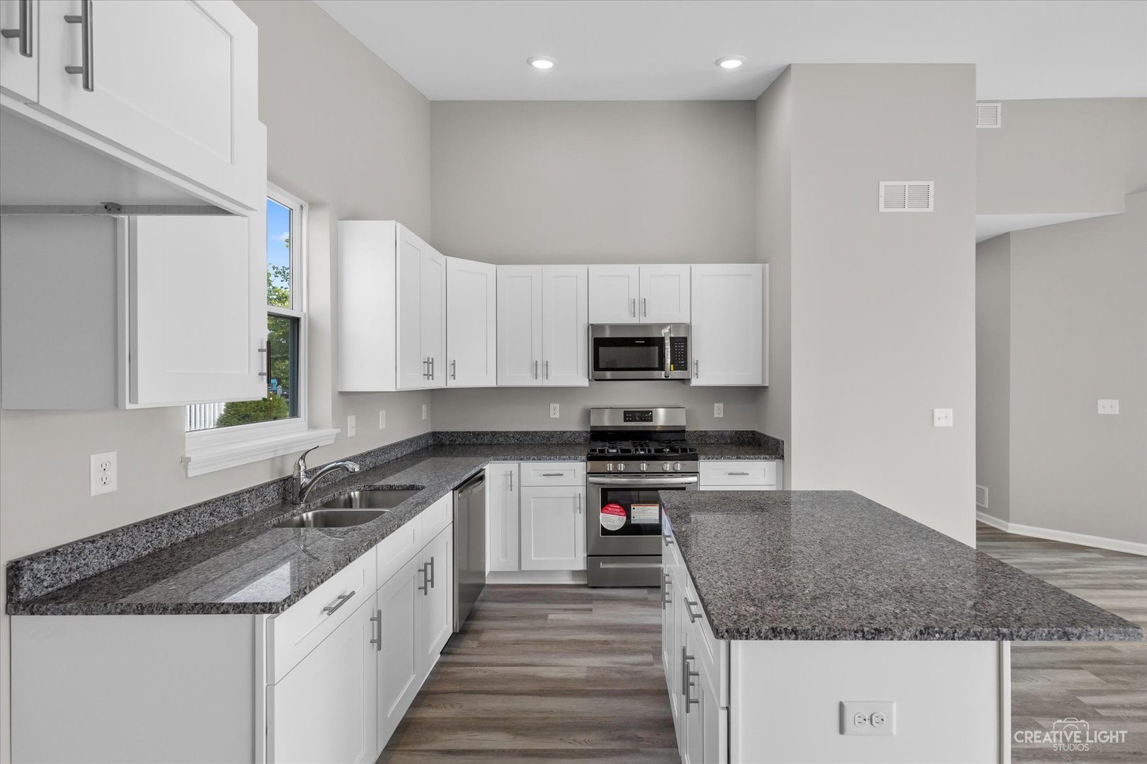 110 Riverbend Drive Genoa, IL 60135 - Photo 19 of 28 a kitchen with stainless steel appliances granite countertop a sink stove and cabinets