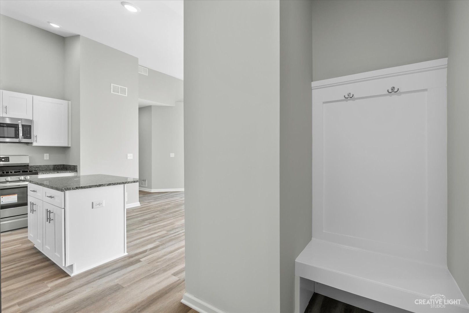 110 Riverbend Drive Genoa, IL 60135 - Photo 21 of 28 a kitchen with white cabinets and white appliances