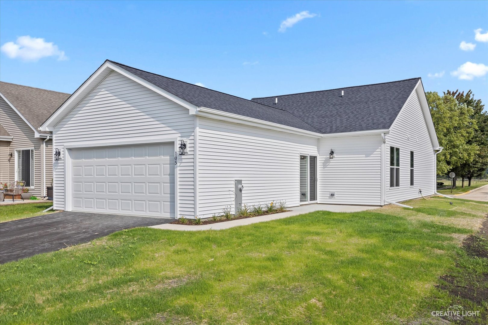 110 Riverbend Drive Genoa, IL 60135 - Photo 25 of 28 a front view of a house with a yard and garage