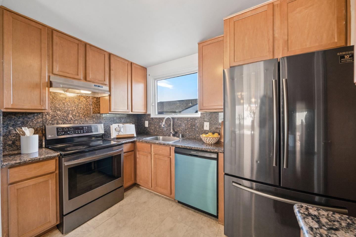654 Foothill Drive Pacifica, CA 94044 - Photo 11 of 24 a kitchen with stainless steel appliances granite countertop a refrigerator stove and sink