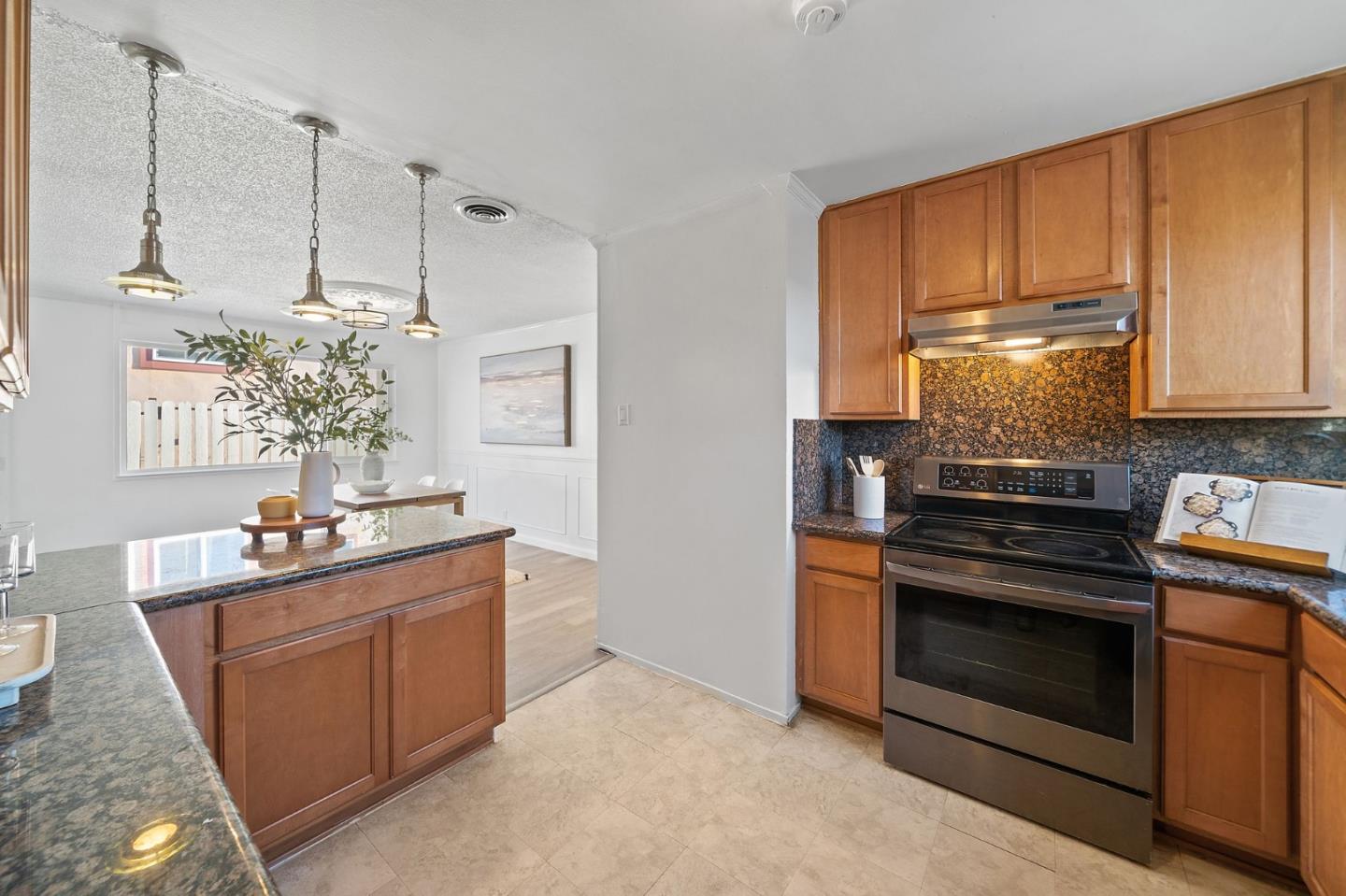 654 Foothill Drive Pacifica, CA 94044 - Photo 12 of 24 a kitchen with stainless steel appliances granite countertop a stove and a refrigerator
