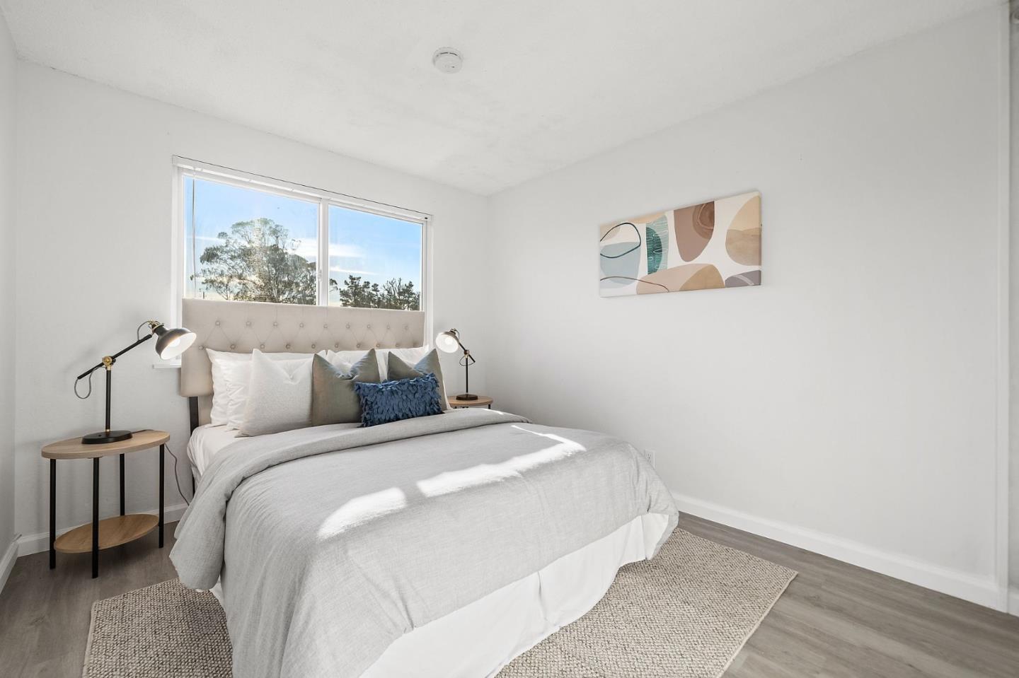 654 Foothill Drive Pacifica, CA 94044 - Photo 17 of 24 a bedroom with a bed and a painting on the wall