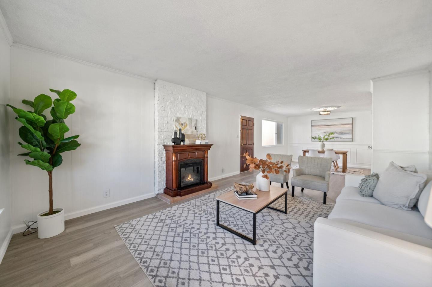 654 Foothill Drive Pacifica, CA 94044 - Photo 5 of 24 a living room with furniture a potted plant and a lamp