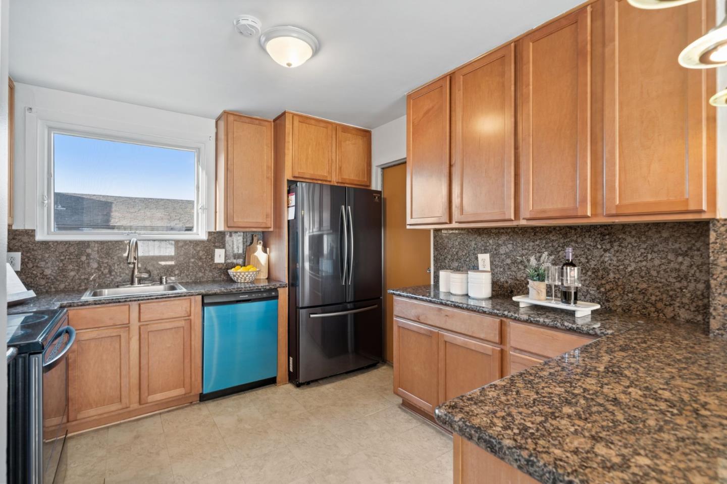 654 Foothill Drive Pacifica, CA 94044 - Photo 10 of 24 a kitchen with stainless steel appliances granite countertop a refrigerator and a sink