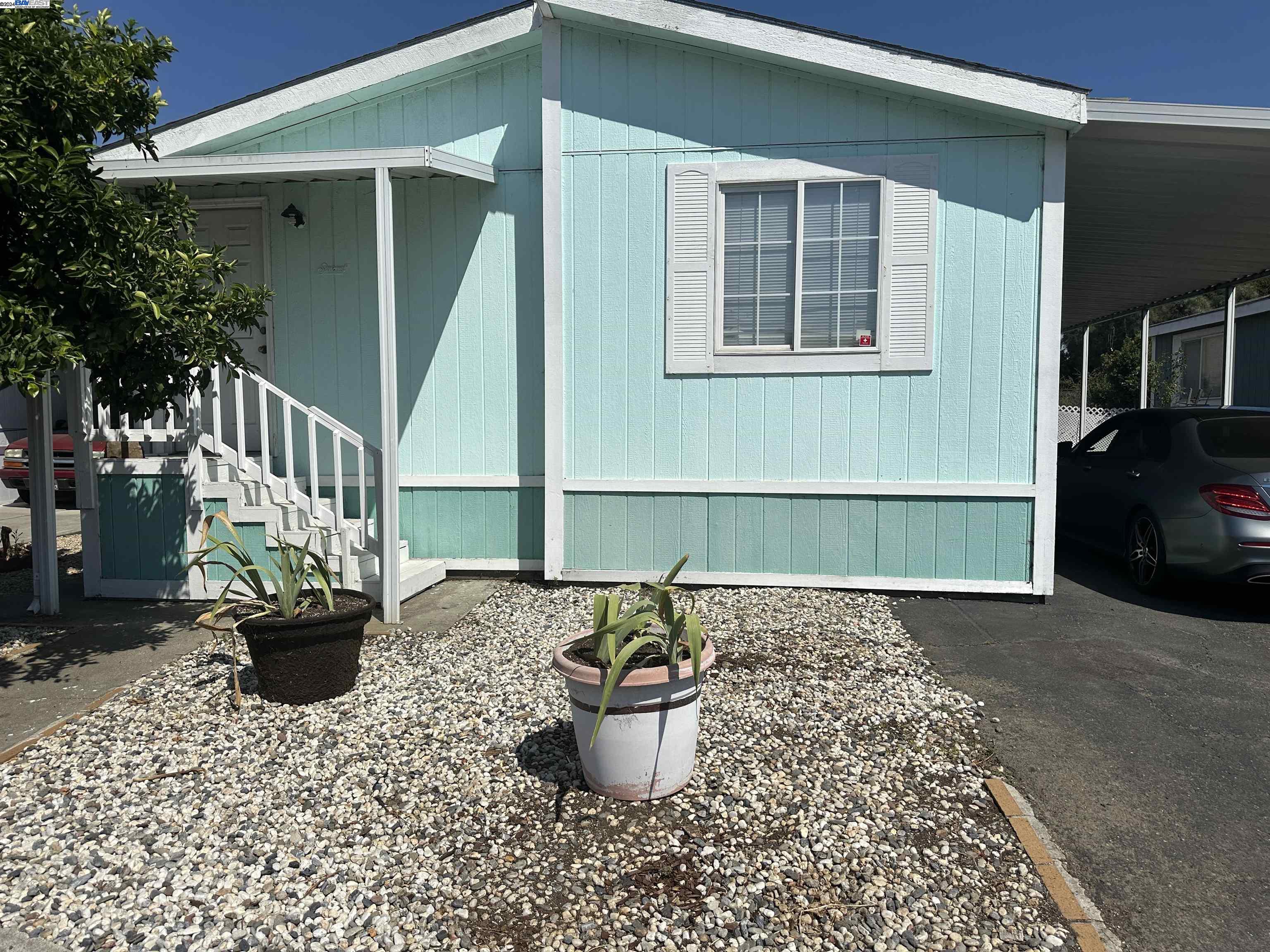 711 Old Canyon Road, Unit 8 Fremont, CA 94536 - Photo 1 of 1 a front view of a house with patio