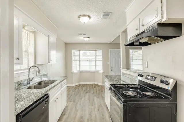 a kitchen that has a sink and a stove