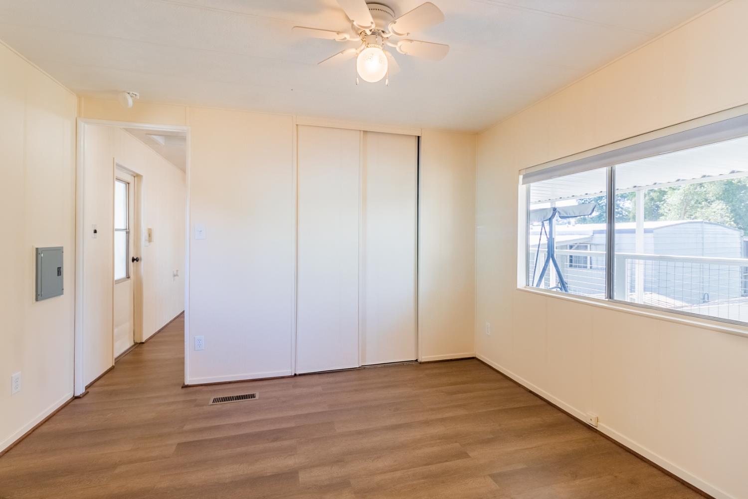 150 Clinton Road, Unit 5 Jackson, CA 95642 - Photo 14 of 22 a view of an empty room with wooden floor and a window