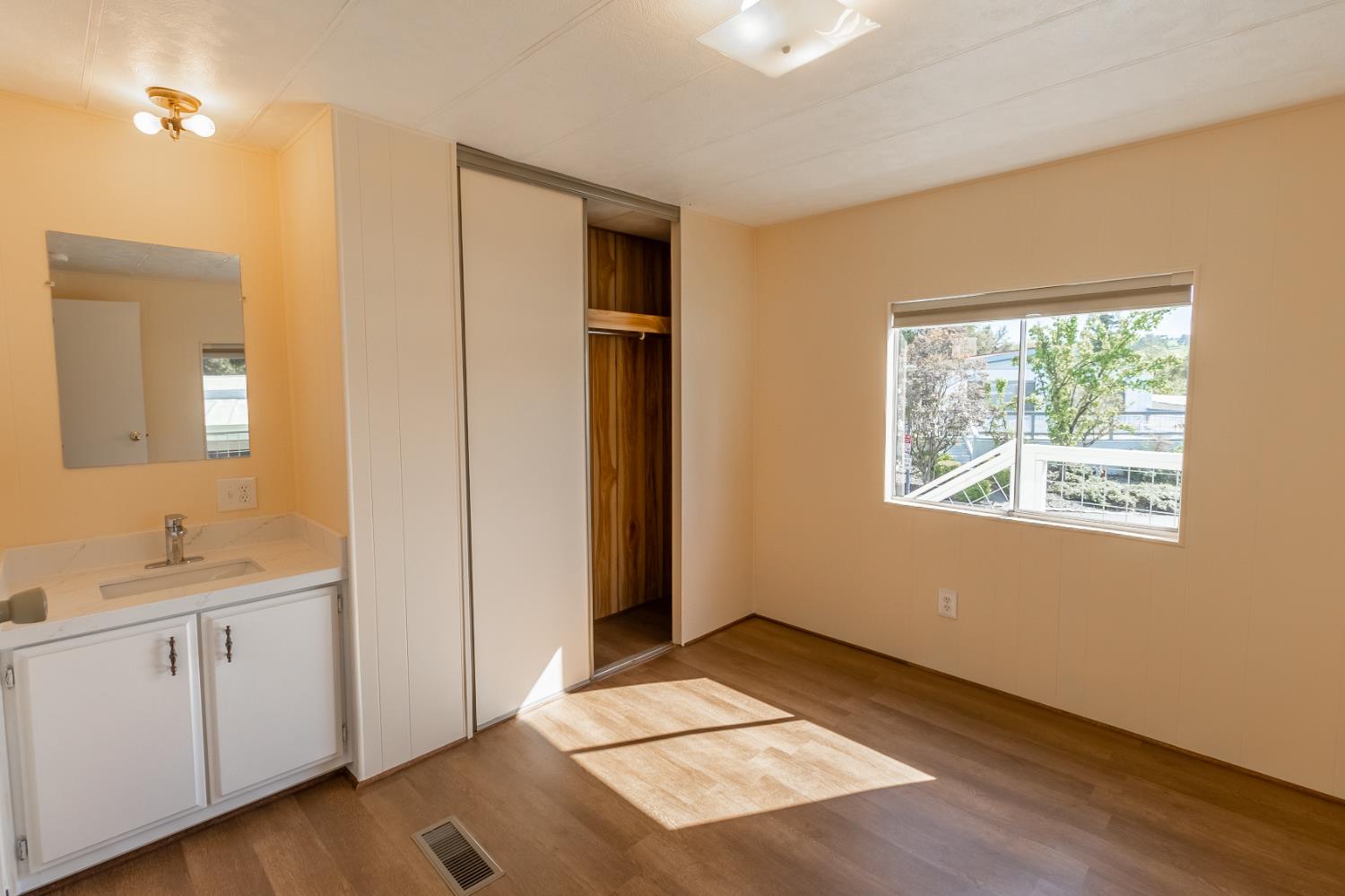 150 Clinton Road, Unit 5 Jackson, CA 95642 - Photo 15 of 22 a view of an empty room with window and wooden floor