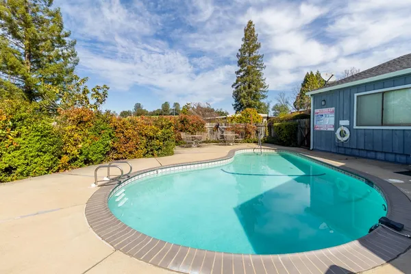 a view of a swimming pool with a yard