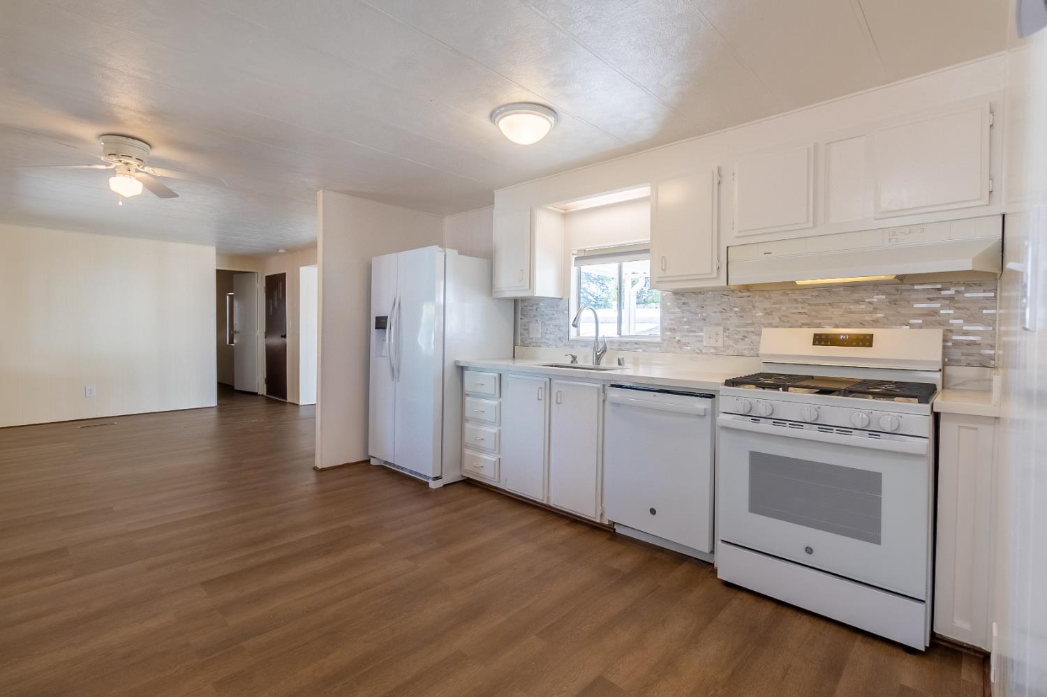 150 Clinton Road, Unit 5 Jackson, CA 95642 - Photo 5 of 22 a kitchen with stainless steel appliances white cabinets and a refrigerator