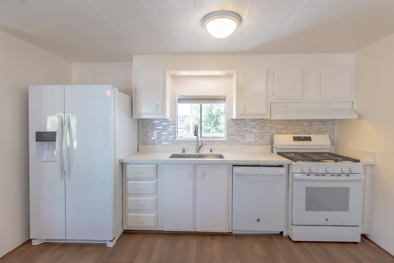 150 Clinton Road, Unit 5 Jackson, CA 95642 - Photo 7 of 22 a kitchen with white cabinets and white appliances