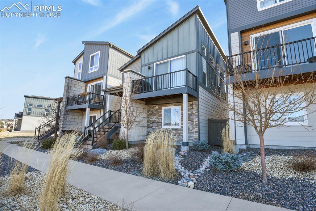 11314 Modern Meadow Loop Colorado Springs, CO 80921 - Photo 3 of 30 a view of a brick house with many windows