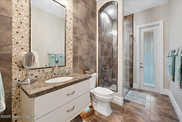 a spacious bedroom with a bed and a chandelier