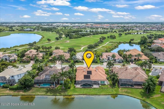 an aerial view of a house with a swimming pool yard and outdoor seating