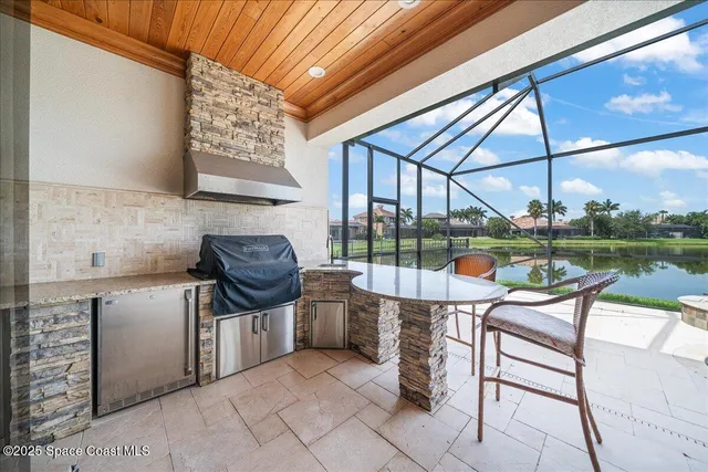 an aerial view of a city with lake view in back