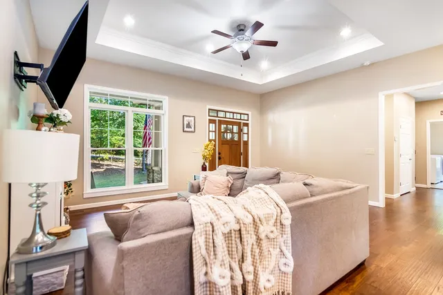 a kitchen with stainless steel appliances granite countertop a stove top oven a refrigerator a sink dishwasher a dining table and chairs with wooden floor