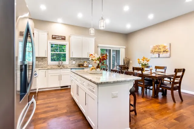 a bedroom with a bed a dresser and chair