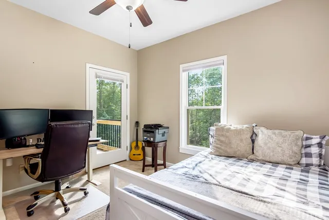 a bedroom with a bed and a television