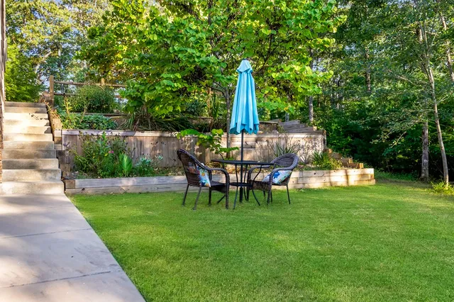 a living room with furniture white walls and a chandelier