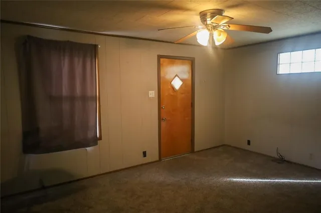 a view of empty room with a fan and fan