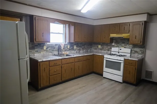 a kitchen with a white cabinets and white appliances
