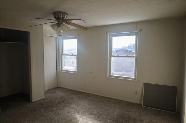 a view of an empty room and a window