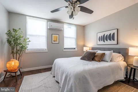 a bedroom with a large bed and a chandelier