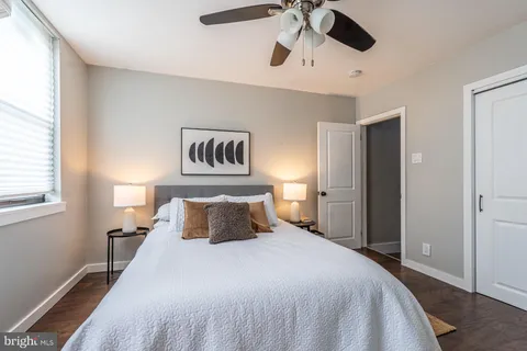 a bedroom with a large bed and a chandelier