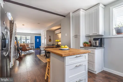 a kitchen with a stove a sink and a refrigerator