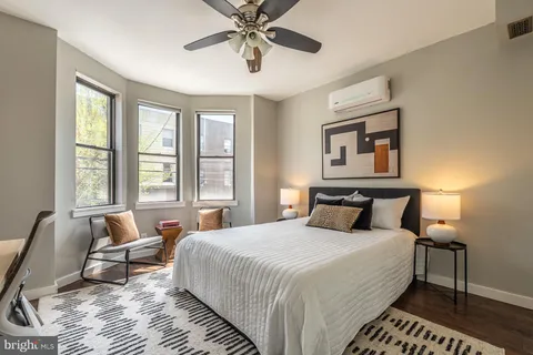 a bedroom with bed and a chandelier