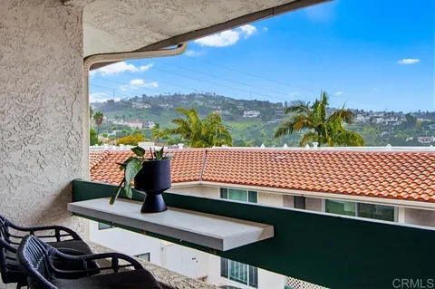 a view of a balcony with floor to ceiling windows with wooden floor
