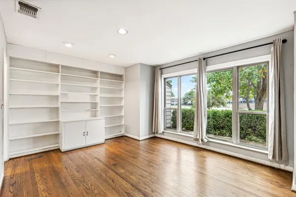 a view of room with wooden floor and window