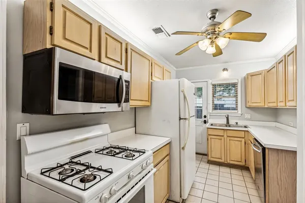 a kitchen with stainless steel appliances a stove a sink and a refrigerator