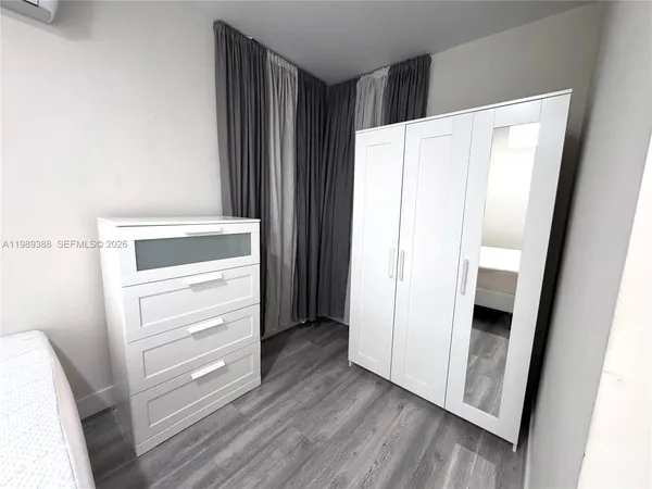 a view of walk in closet with empty racks