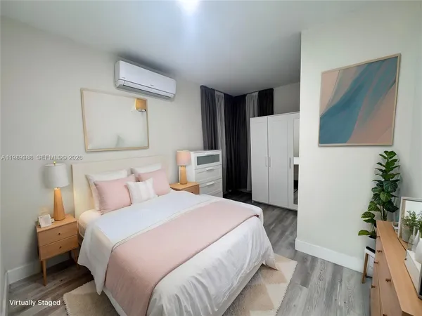 a bedroom with a bed and a potted plant