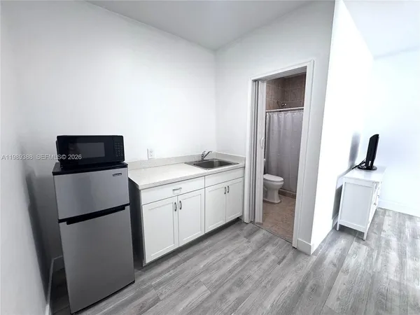 a kitchen with a refrigerator sink and stove