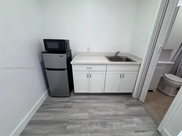 a utility room with sink dryer and washer
