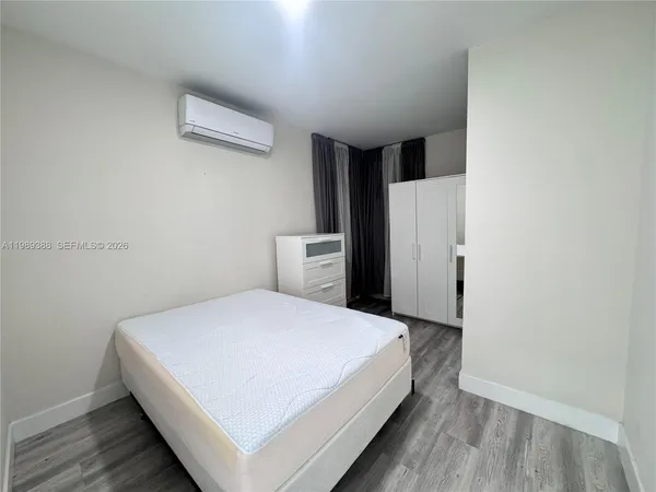 a large bed sitting in a kitchen next to a window