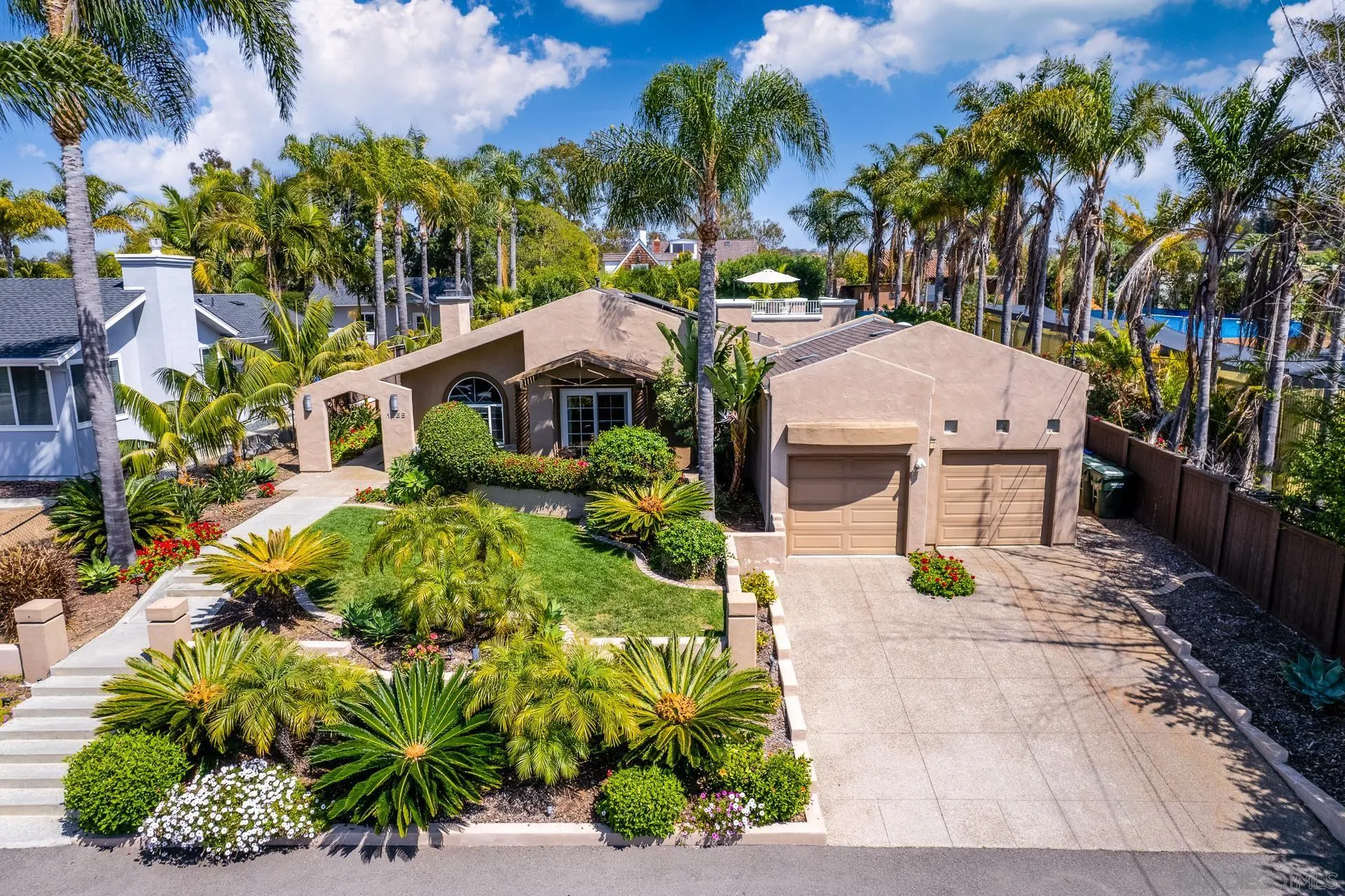 an aerial view of a house with a yard and sitting area