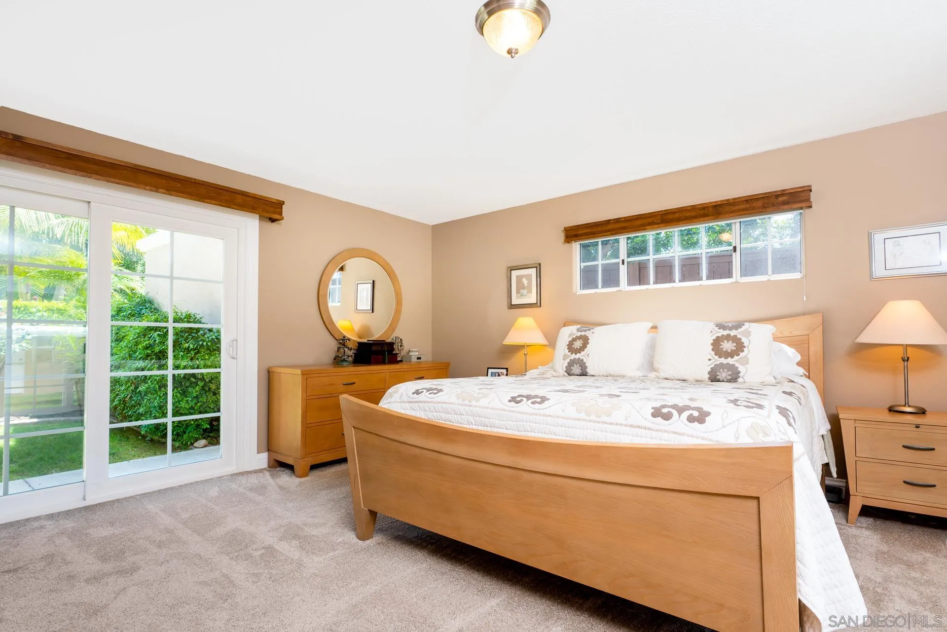 1269 Rainbow Ridge Lane Encinitas, CA 92024 - Photo 11 of 27 a bed room with a bed a mirror and a window