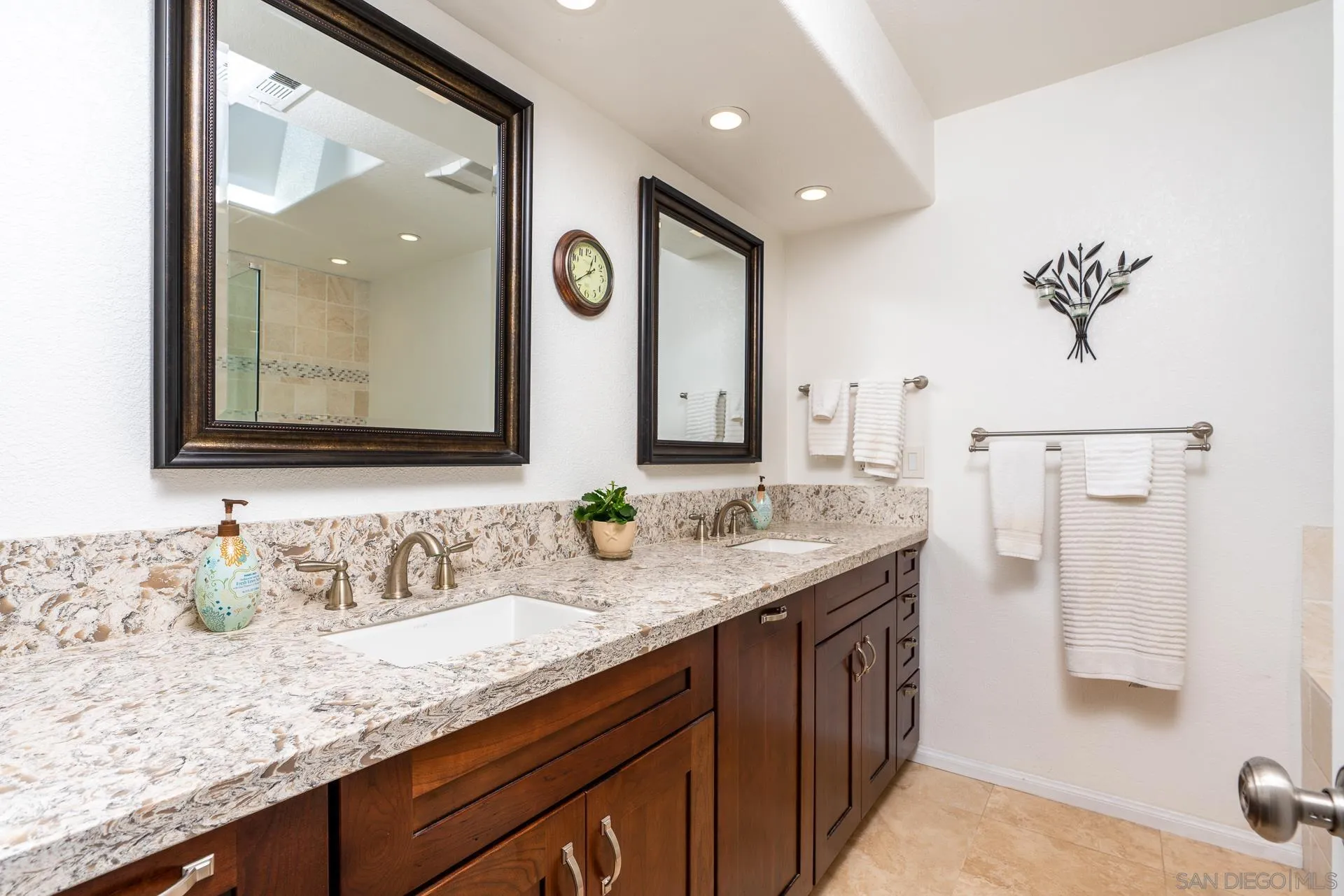 1269 Rainbow Ridge Lane Encinitas, CA 92024 - Photo 13 of 27 a bathroom with a granite countertop sink and a mirror
