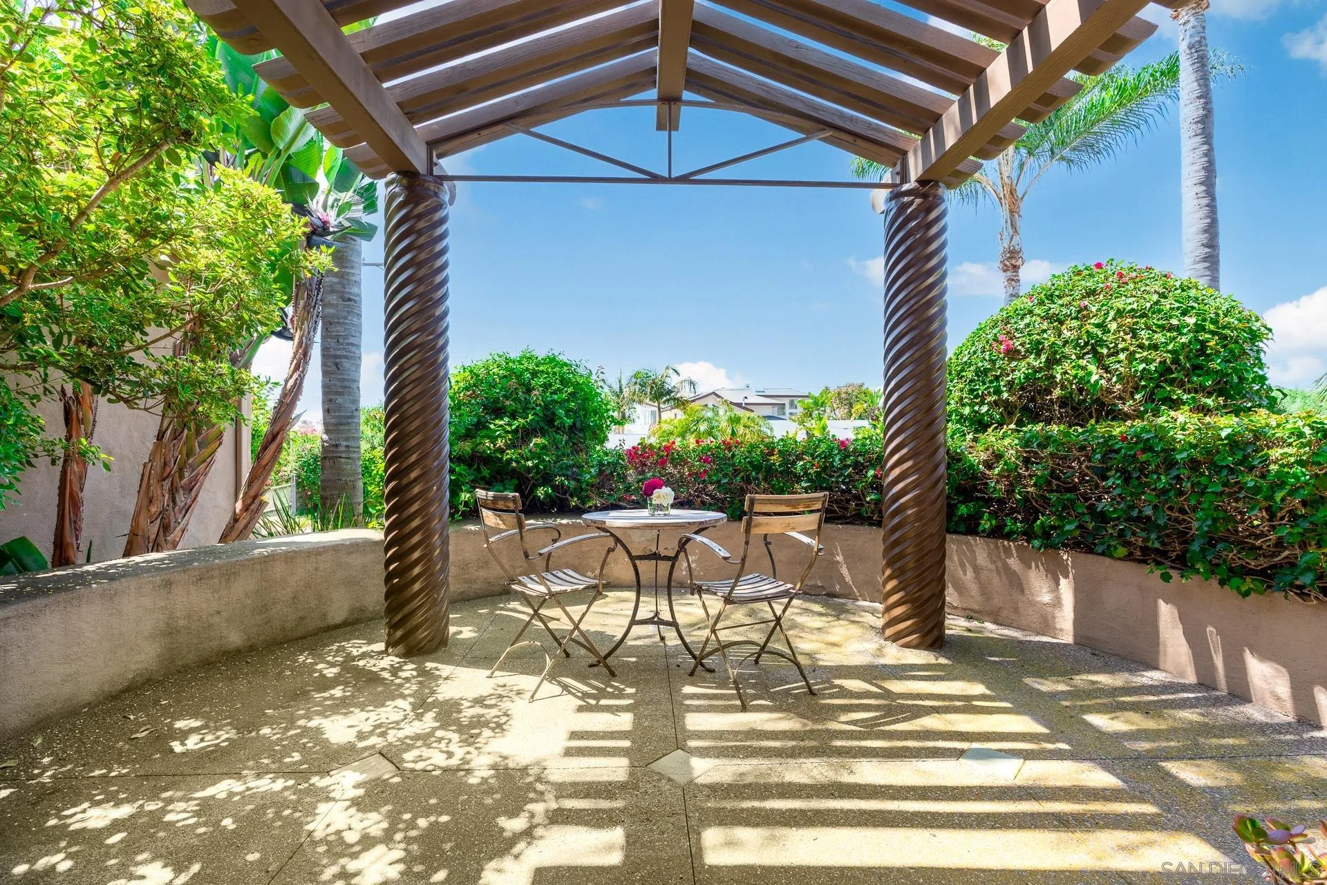 1269 Rainbow Ridge Lane Encinitas, CA 92024 - Photo 19 of 27 a view of patio with table and chairs and potted plants