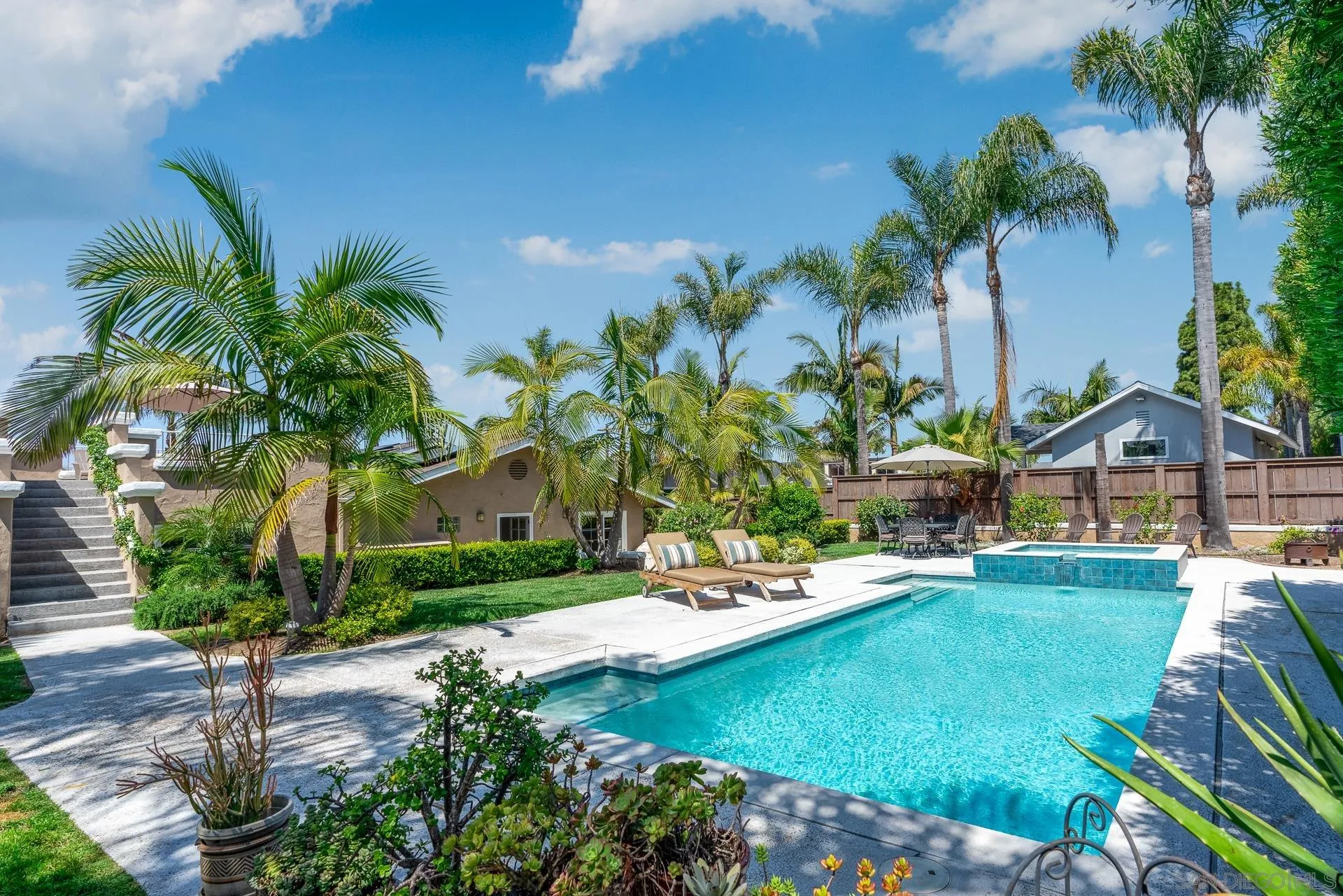 1269 Rainbow Ridge Lane Encinitas, CA 92024 - Photo 21 of 27 a view of a house with swimming pool and sitting area