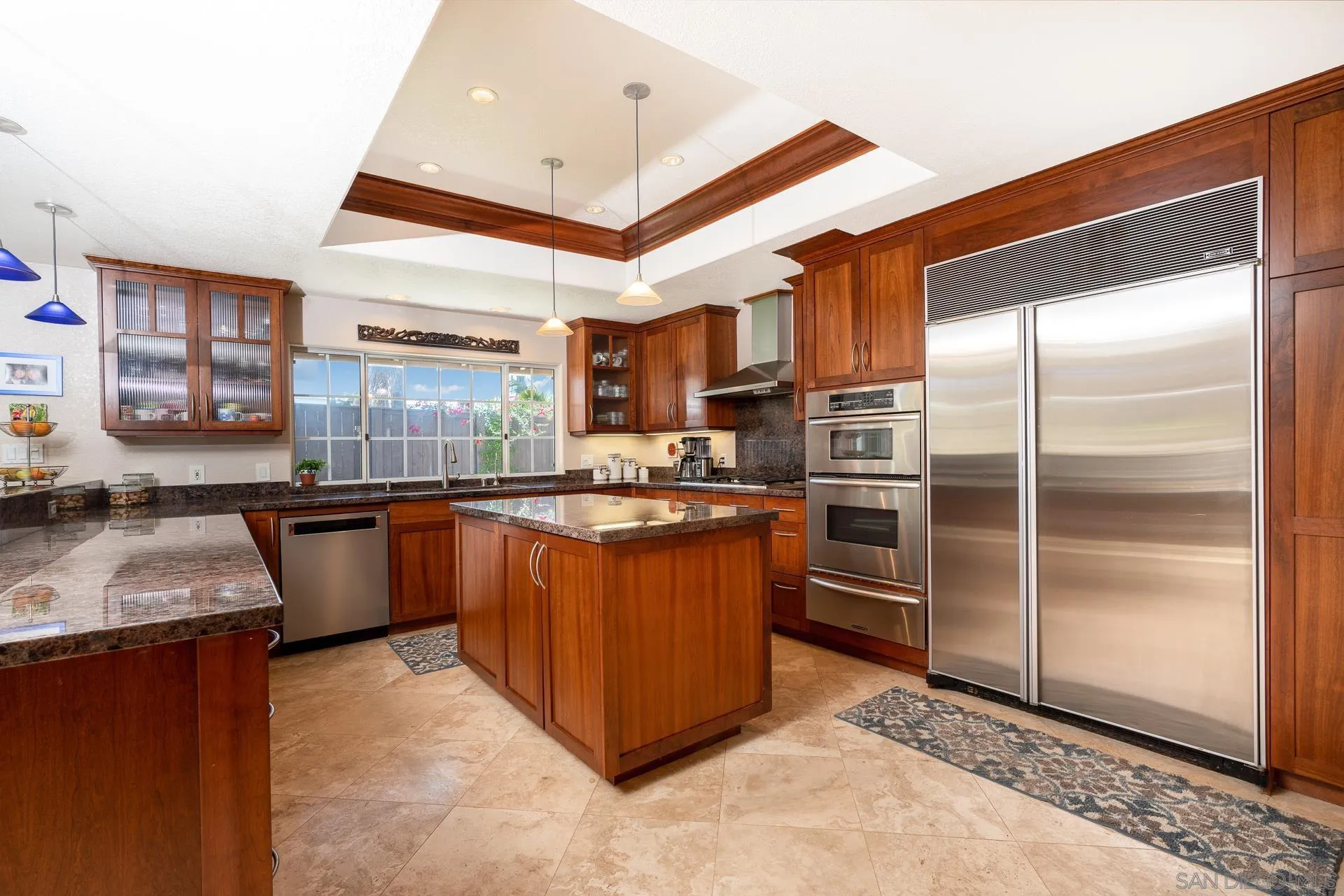 1269 Rainbow Ridge Lane Encinitas, CA 92024 - Photo 9 of 27 a kitchen with stainless steel appliances granite countertop a refrigerator a sink and a stove