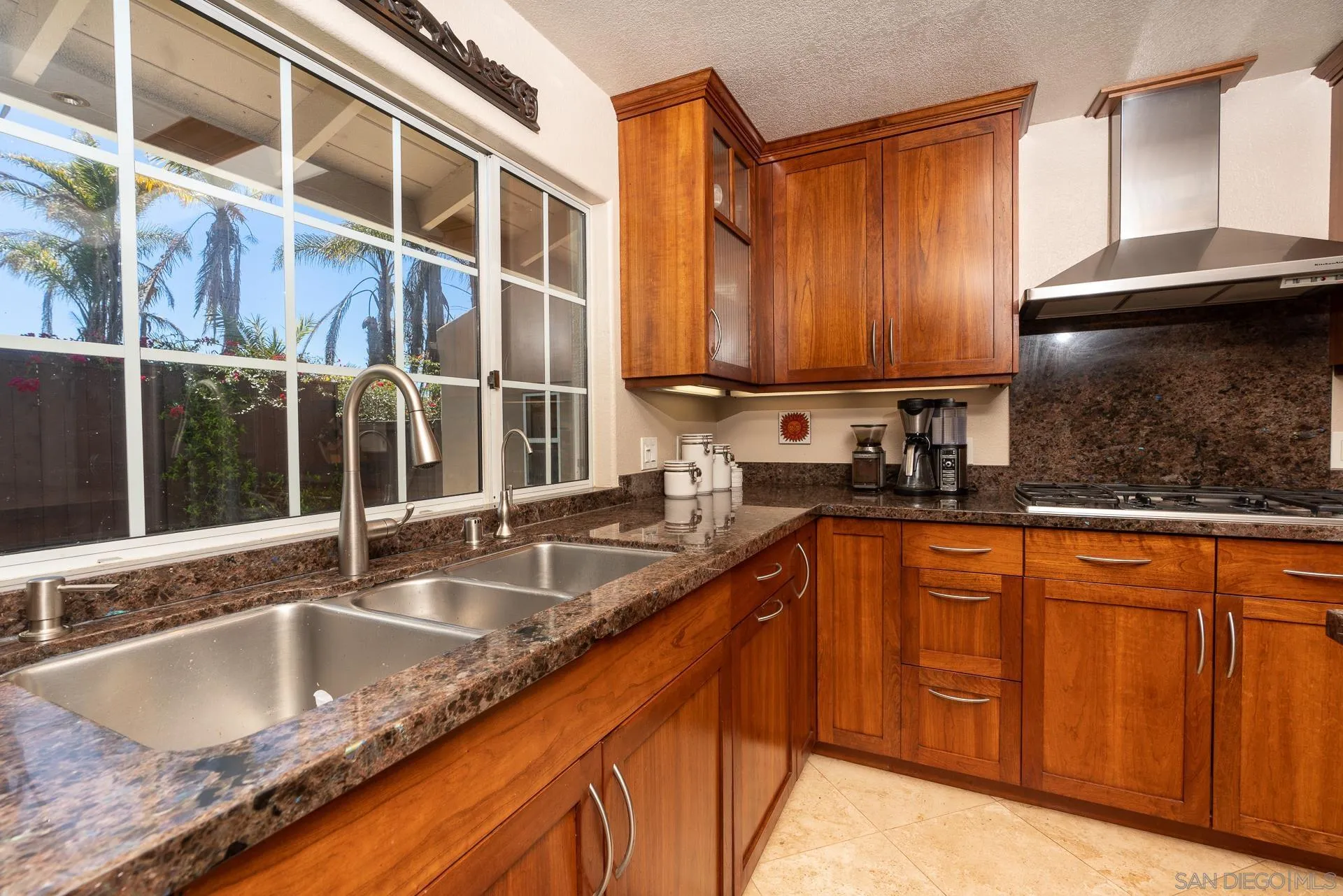 1269 Rainbow Ridge Lane Encinitas, CA 92024 - Photo 10 of 27 a kitchen with stainless steel appliances granite countertop a sink a stove and a counter top space