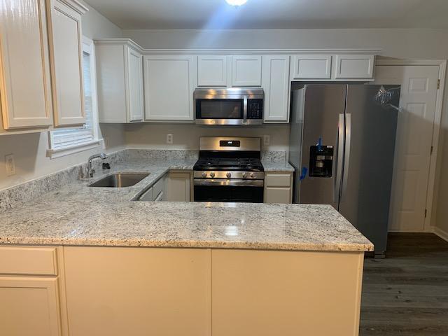8320 Hobhouse Circle Raleigh, NC 27615 - Photo 7 of 16 a kitchen with granite countertop a refrigerator and a sink