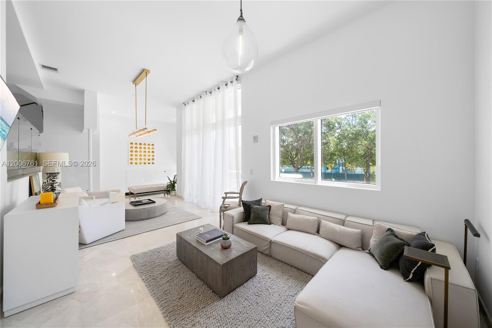 400 Alton Road, Unit TH1A Miami Beach, FL 33139 - Photo 12 of 32 a living room with furniture and a large window